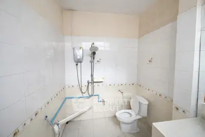 Spacious bathroom with shower and toilet, ideal for modern living.