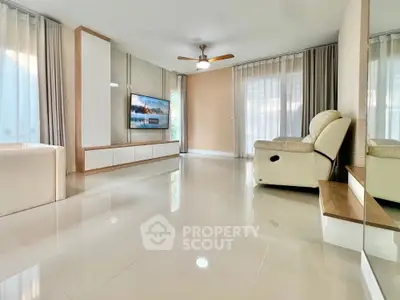 Spacious modern living room with sleek flooring and cozy seating area.