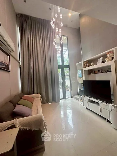 Spacious living room with high ceilings and modern decor