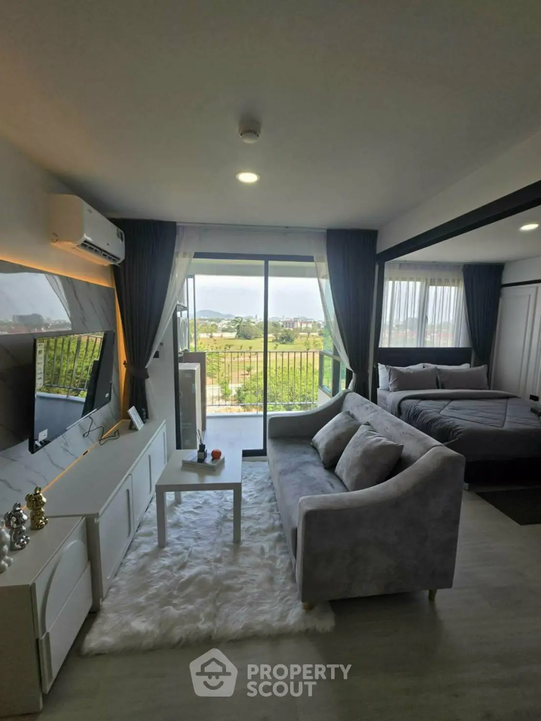 Modern living room with cozy sofa and scenic balcony view in stylish apartment