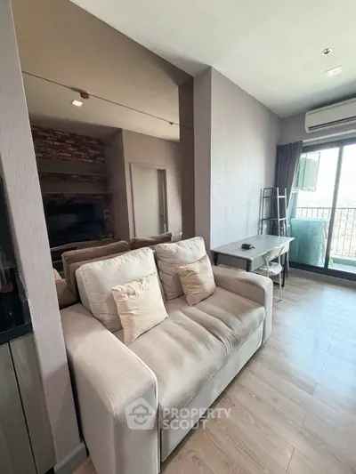 Modern living room with cozy sofa and balcony view in stylish apartment