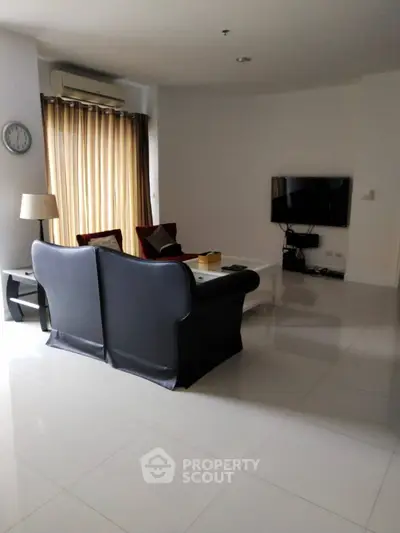 Modern living room with sleek furniture and wall-mounted TV