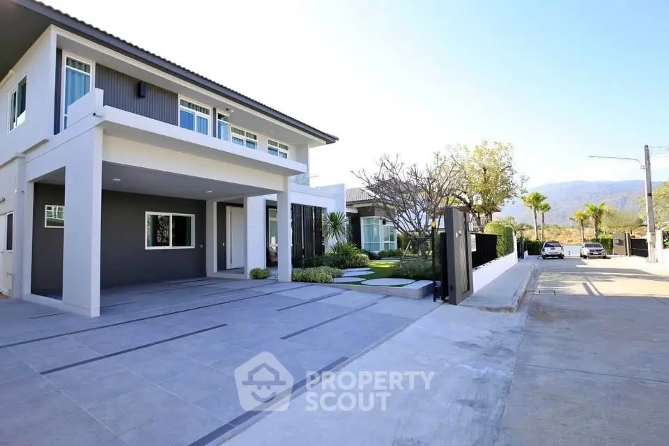 Modern two-story house with spacious driveway and landscaped garden in a serene neighborhood.