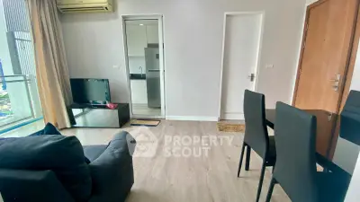 Modern living room with sleek furniture and open kitchen view in a stylish apartment.