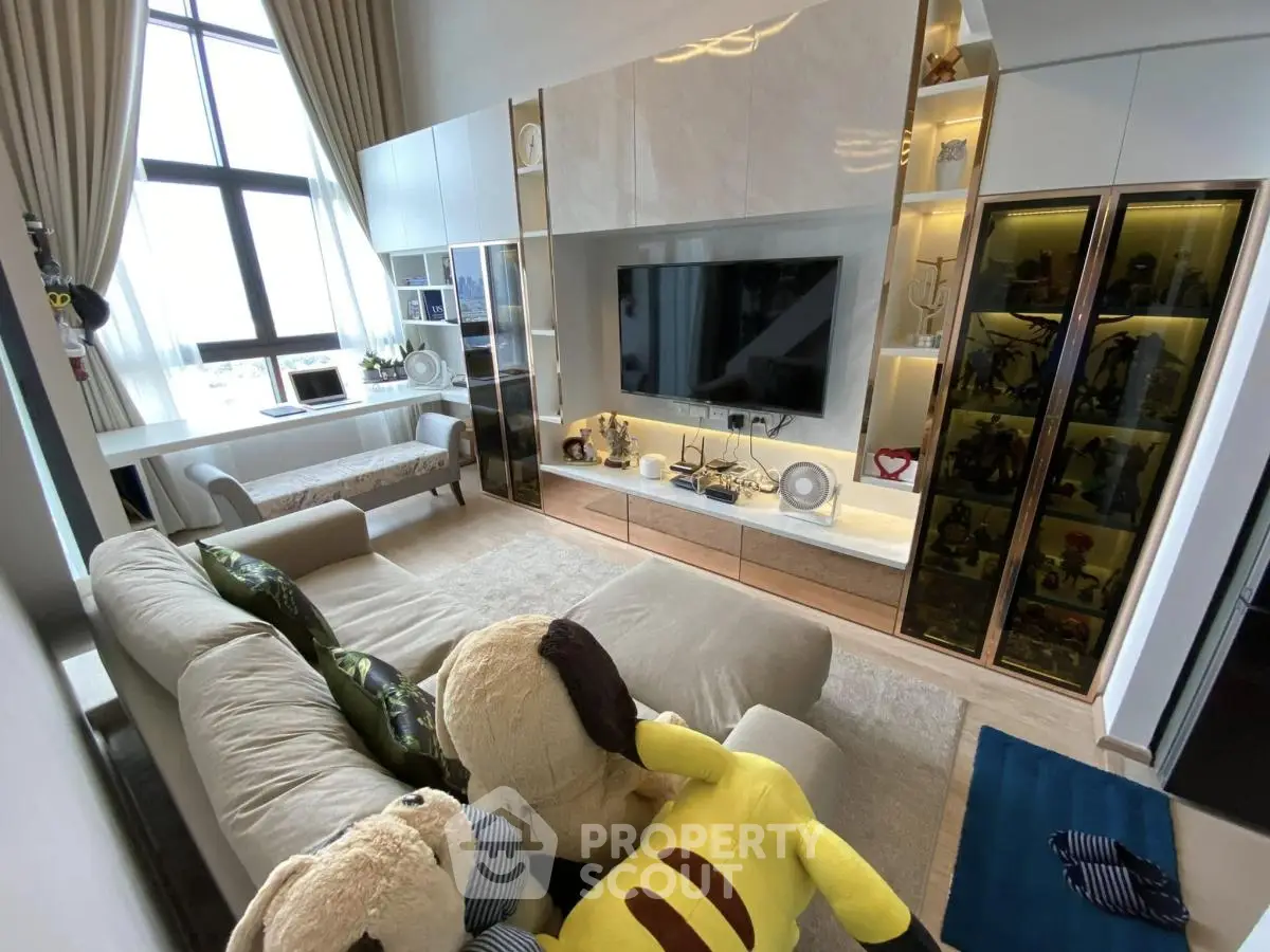 Luxurious living room with plush sofa, large TV, and elegant decor