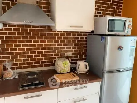 Modern kitchen with brick backsplash, stainless steel appliances, and wooden countertops.