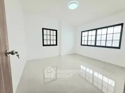Spacious empty room with large windows and glossy tiled floor, perfect for customization.