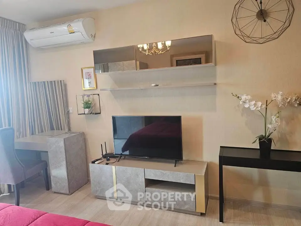 Modern living room with stylish decor and wall-mounted TV, perfect for relaxation and entertainment.