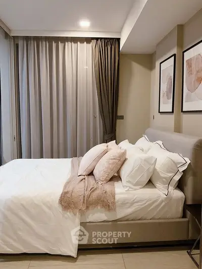 Elegant bedroom with cozy bed, stylish decor, and soft lighting for a serene ambiance.