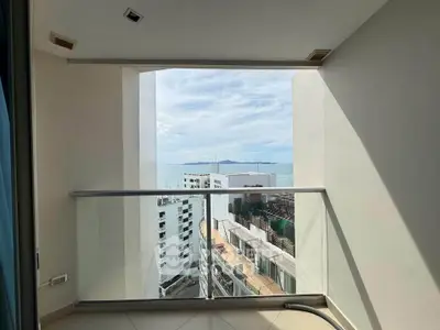 Stunning high-rise balcony with panoramic ocean view, perfect for enjoying serene sunsets and cityscape.