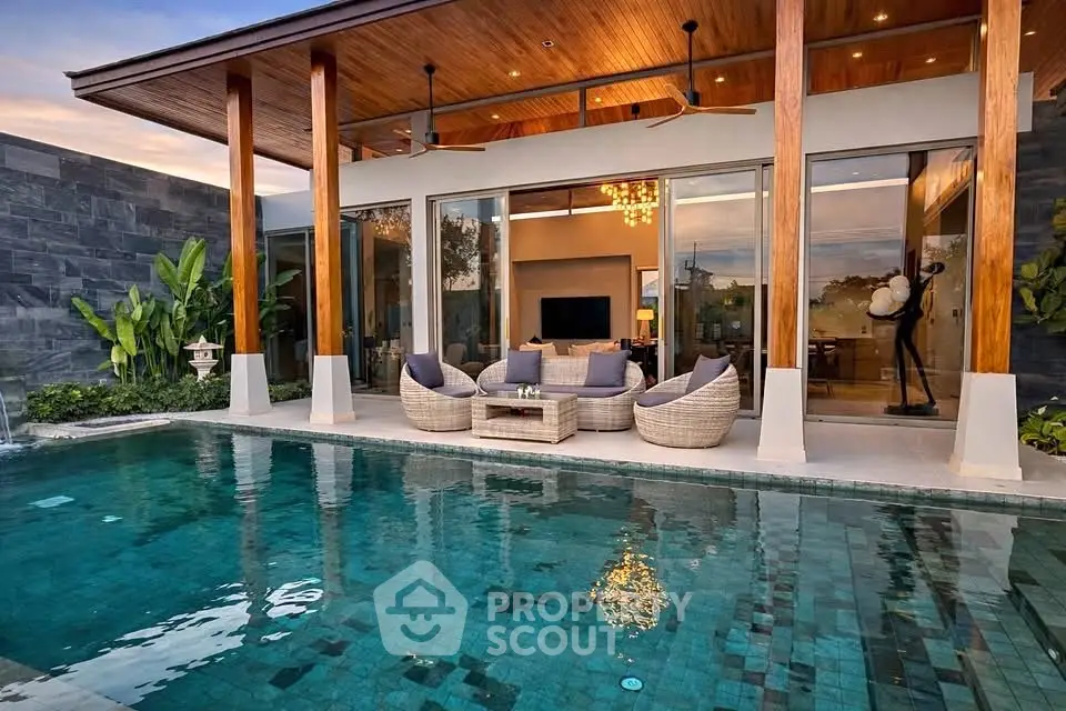 Luxurious modern villa with private pool and stylish outdoor seating area, perfect for relaxation.
