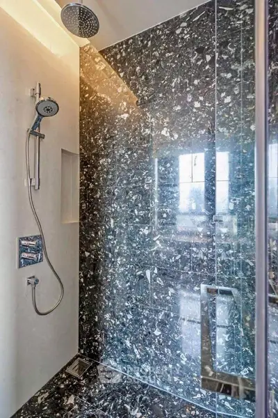 Luxurious marble shower with modern fixtures in elegant bathroom design