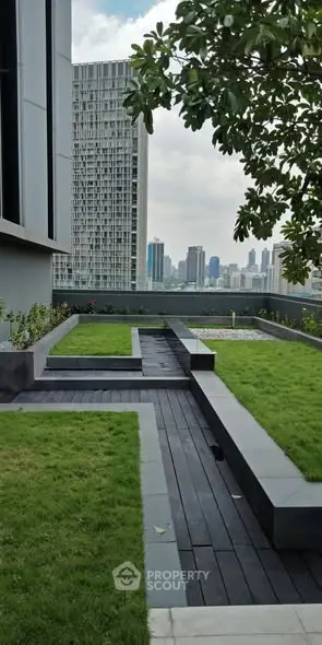 Modern rooftop garden with city skyline view and lush greenery