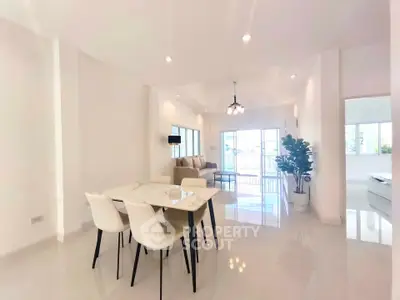Spacious modern living room with elegant dining area and natural light