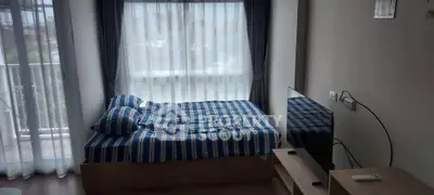 Cozy bedroom with large window and modern furnishings, perfect for natural light lovers.