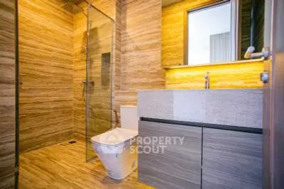 Luxurious modern bathroom with elegant marble finishes and sleek fixtures.