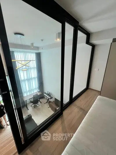 Modern loft-style apartment with floor-to-ceiling windows and stylish interior design.