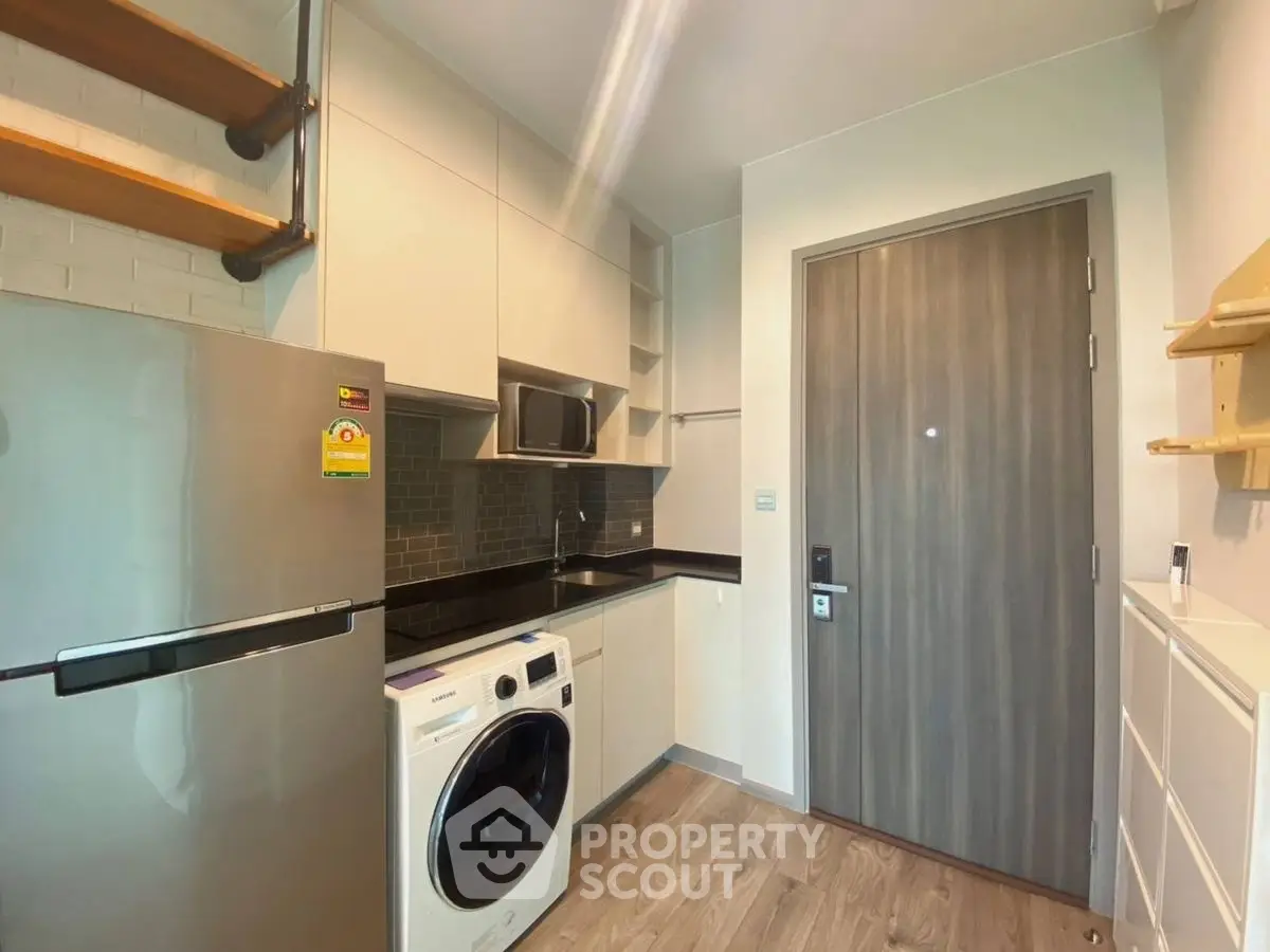 Modern kitchen with sleek appliances and wooden accents
