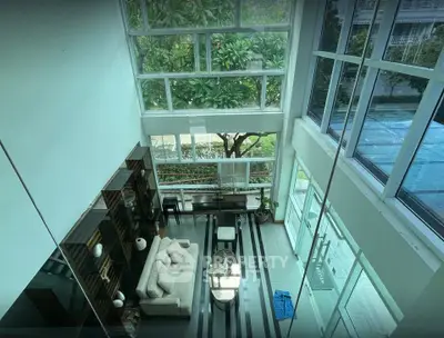 Stunning modern living room with floor-to-ceiling windows and lush garden view