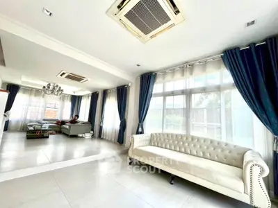 Spacious living room with elegant sofa and large windows for natural light