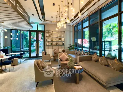 Luxurious modern living room with elegant lighting and large windows in a stylish apartment complex.