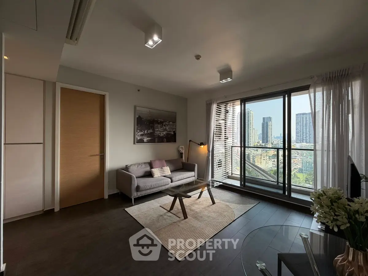 Modern living room with city view, stylish decor, and large windows in urban apartment.