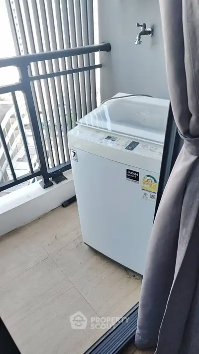 Compact balcony with washing machine and modern railing in urban apartment