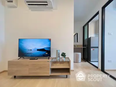 Modern living room with sleek TV stand and open kitchen layout