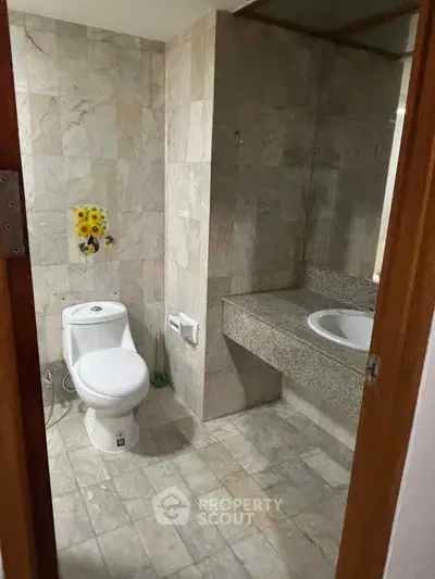 Spacious bathroom with modern fixtures and elegant stone tiles