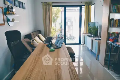 Modern living room with sleek furniture and large window for natural light