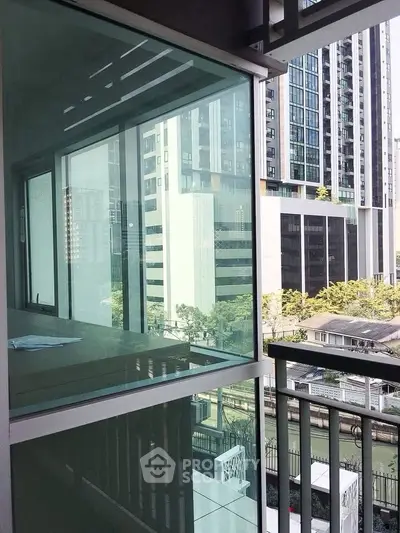 Modern urban balcony with glass railing and city view