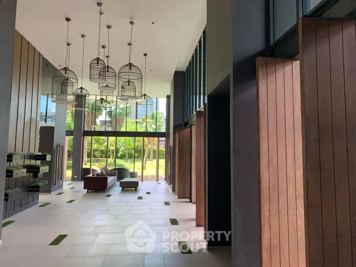 Luxurious modern lobby with high ceilings and stylish lighting in a premium residential building.