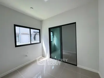 Modern empty room with large windows and sliding glass door