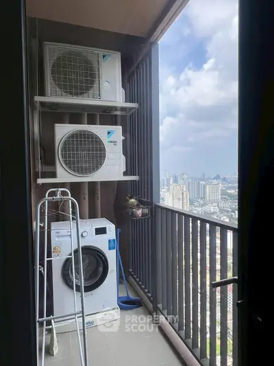 High-rise balcony with city view, featuring washing machine and air conditioning units.