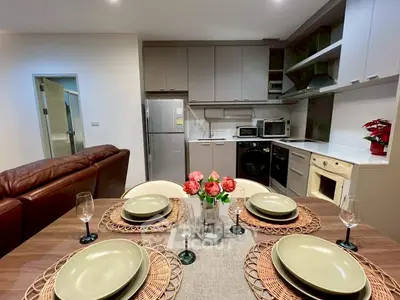 Modern kitchen and dining area with stylish decor and appliances