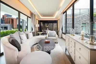 Luxurious modern living room with elegant decor and large windows offering stunning views.