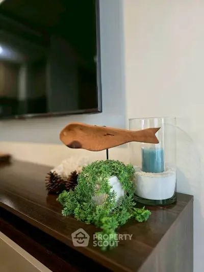 Stylish living room decor with wooden accents and greenery on a modern console table.