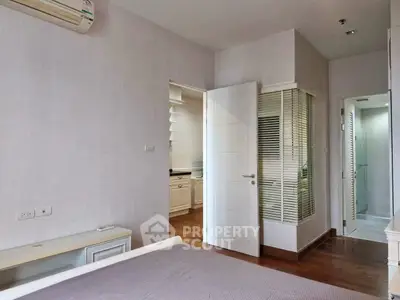 Spacious bedroom with modern design and en-suite bathroom in a stylish apartment.