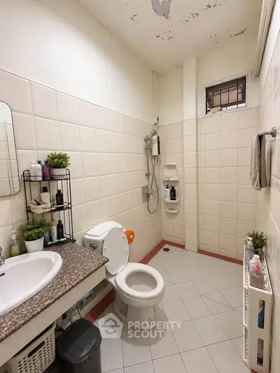 Spacious bathroom with modern fixtures and ample storage in a well-lit setting.