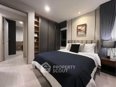 Modern bedroom with stylish decor and cozy ambiance, featuring a comfortable bed and elegant lighting.