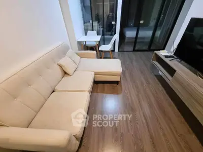 Modern living room with cozy beige sofa and sleek wooden flooring