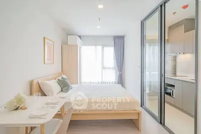 Modern studio apartment with cozy bedroom and sleek kitchen design