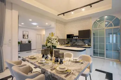 Luxurious open-plan kitchen and dining area with elegant decor and modern finishes.