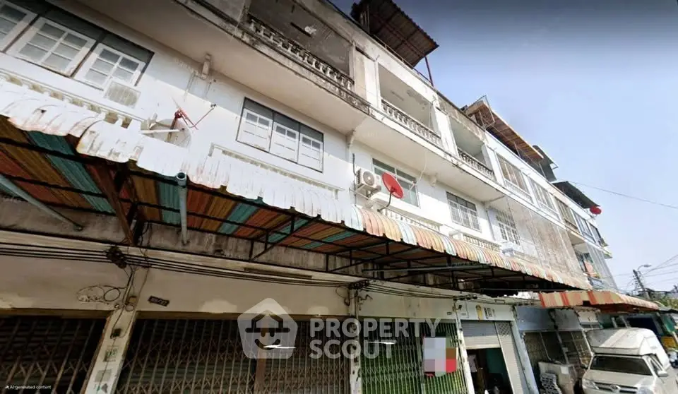 Street view of multi-story building with commercial spaces and residential units.
