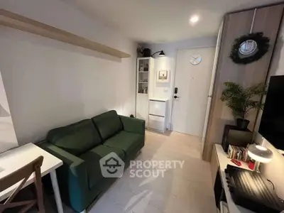 Cozy living room with green sofa, modern decor, and ample natural light