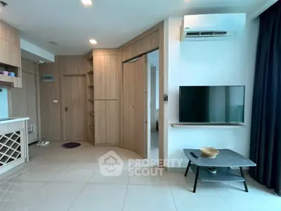 Modern living room with sleek design, featuring built-in storage and air conditioning, perfect for urban living.