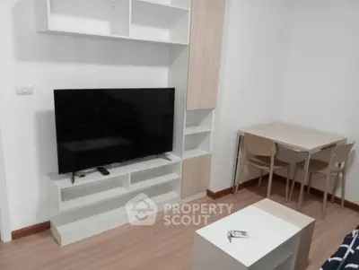 Modern living room with sleek TV setup and cozy dining area