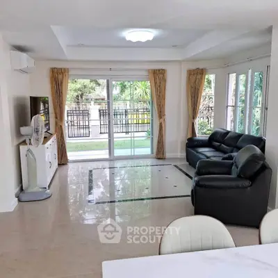 Spacious living room with modern furniture and garden view