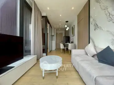 Modern living room with elegant decor and open layout, featuring a cozy sofa and stylish coffee table.