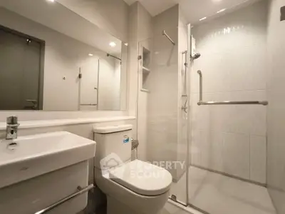 Modern bathroom with sleek shower and elegant fixtures in a contemporary apartment.